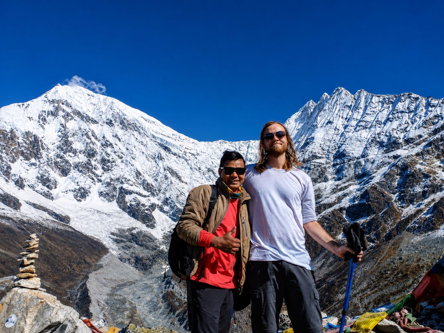 Trekkers posing with panoramic Himalayan views during the Langtang Valley Trek in Nepal.