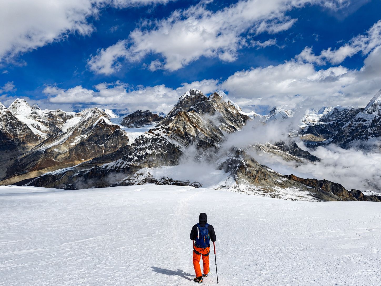 Climber trekking across the Mera Peak glacier surrounded by snow-covered Himalayan mountains during a Mera Peak climbing expedition in Nepal.
