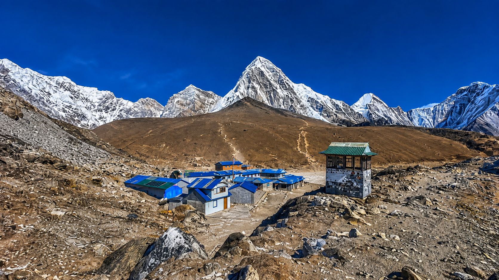 Everest Base Camp settlement with blue-roofed lodges and snow-covered Himalayan peaks